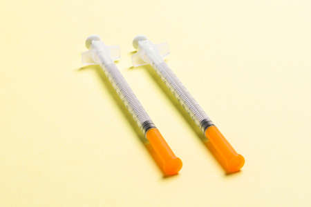 Top view of insulin syringes ready for injection on colorful background. Diabetic concept with copy...