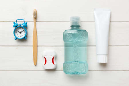Mouthwash and other oral hygiene products on colored table top view with copy space. flat lay. dental hygiene. Oral care products and space for text on light background. concept.の写真素材