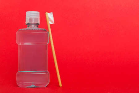 Mouthwash and other oral hygiene products on colored table top view with copy space. flat lay. dental hygiene. Oral care products and space for text on light background. concept.の写真素材