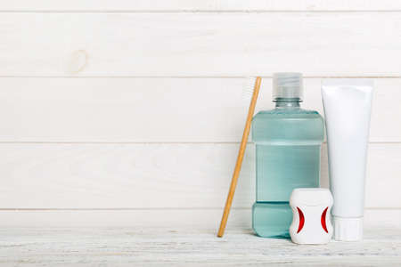 Mouthwash and other oral hygiene products on colored table top view with copy space. flat lay....