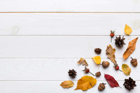 autumn composition. Pattern made of dried leaves and other design accessories on table. Flat lay,...