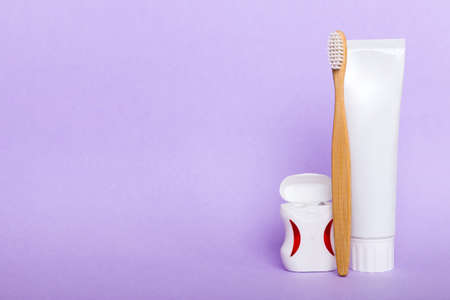 toothpaste and toothbrush top view with copy space on colored background. flat lay. dental hygiene. Oral care products on light background. body care concept.の写真素材