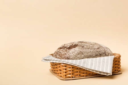 Freshly baked bread on basket against natural background. Perspective view bread copy space.