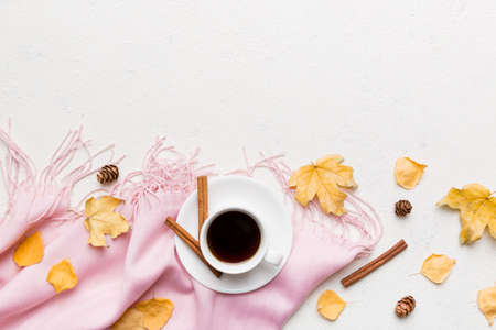 Flat lay composition with colorful Autumn cup of coffee and leaves on a color background. top view.