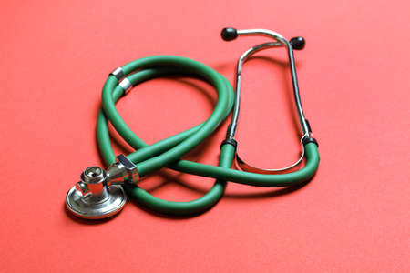 Top view of green medical stethoscope on colorful background with copy space. medicine equipment concept.の写真素材