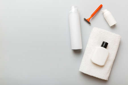 shaving man set. shaving machine, towel, lotion and shaving foam on colored background. Men bath accessories top view.の写真素材