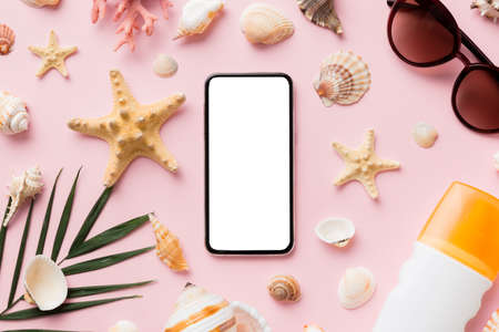Flat lay composition with Phone and beach accessories on colored background. Smartphone with blank...