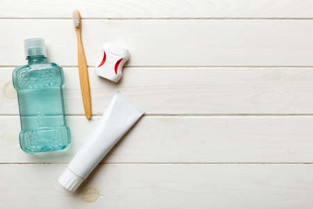 Mouthwash and other oral hygiene products on colored table top view with copy space. flat lay....