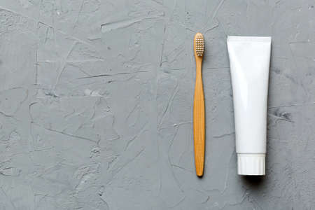 toothpaste and toothbrush top view with copy space on colored background. flat lay. dental hygiene. Oral care products on light background. body care concept.の写真素材