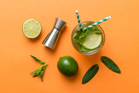 Caipirinha, Mojito cocktail, vodka or soda drink with lime, mint and straw on table background....