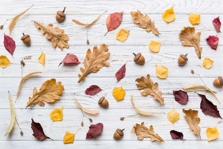 autumn composition. Pattern made of dried leaves and other design accessories on table. Flat lay,...
