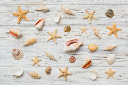 Summer time concept Flat lay composition with beautiful starfish and sea shells on colored table,...