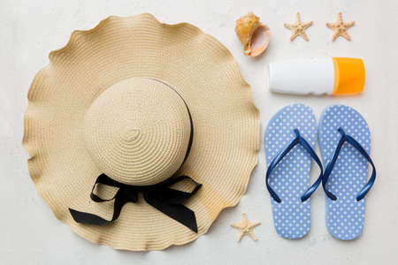 Summer vacation concept flat lay. straw hat beach accessories and towel top view. Space for text....