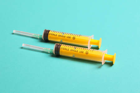 Top view of medical syringes on colorful background. Health care concept with copy space.