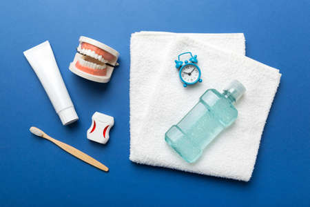 Mouthwash and other oral hygiene products on colored table top view with copy space. flat lay. dental hygiene. oral care kit. Dentist concept.の写真素材