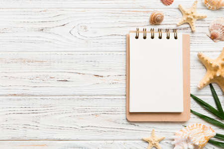 Blank writing book with summer beach accessories on background, copy space. Flat lay with copy space.の写真素材