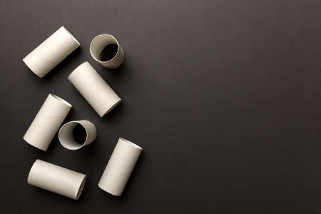 Flat lay composition with empty toilet paper rolls and space for text on color background. Recyclable paper tube with metal plug end made of kraft paper or cardboard.の写真素材