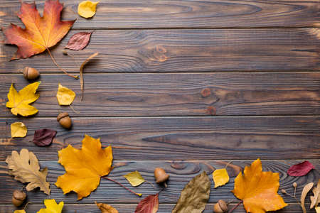 autumn composition. Pattern made of dried leaves and other design accessories on table. Flat lay,...