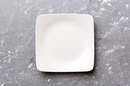 Top view of empty square plate on cement background. Empty space for your design.の写真素材