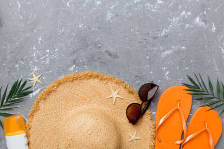 Summer vacation concept flat lay. straw hat beach accessories and towel top view. Space for text....