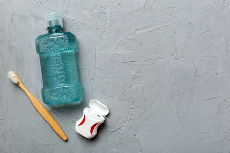 Mouthwash and other oral hygiene products on colored table top view with copy space. flat lay. dental hygiene. Oral care products and space for text on light background. concept.の写真素材