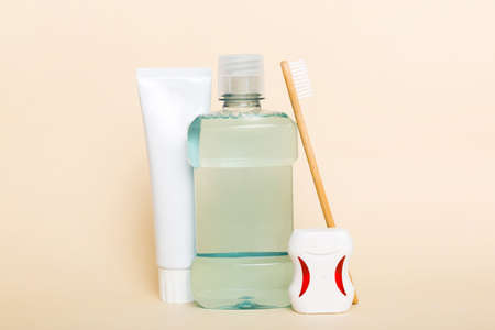 Mouthwash and other oral hygiene products on colored table top view with copy space. flat lay. dental hygiene. Oral care products and space for text on light background. concept.の写真素材