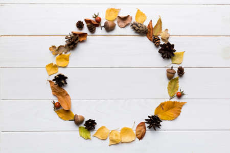 Autumn composition made of dried leaves, cones and acorns on table. Flat lay, top view.の写真素材