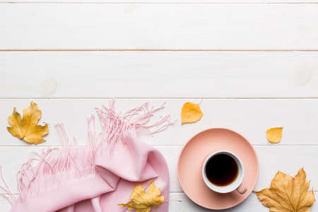 Flat lay composition with colorful Autumn cup of coffee and leaves on a color background. top view.の写真素材
