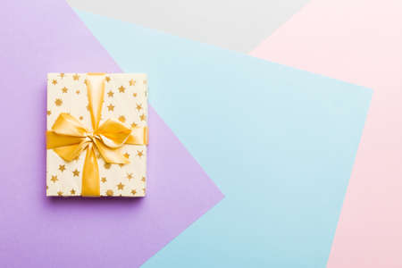 holiday paper present tied yellow ribbon bow top view with copy space. Flat lay holiday background. birthday or christmas present. Christmas gift box concept with copy space.の写真素材