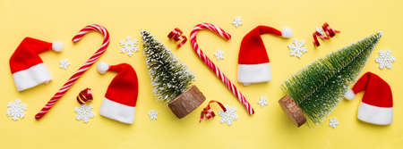 Flat lay composition with christmas trees on color background. Top view with copy space.