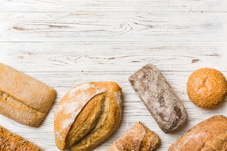 Homemade natural breads. Different kinds of fresh bread as background, top view with copy space.