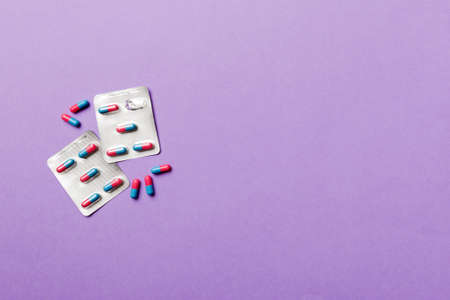 Protective face masks or surgical masks, medicine pills and thermometer on table background. coronavirus disease. Corona virus concept. Space for text.の写真素材