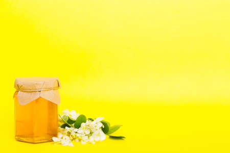 robinia honey bollte with acacia blossoms on colored table.の写真素材