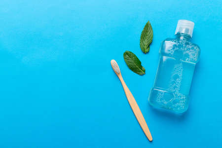 Mouthwash and fresh mint on colored background, top view with copy space for text.の写真素材