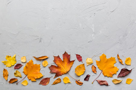 autumn composition. Pattern made of dried leaves and other design accessories on table. Flat lay,...