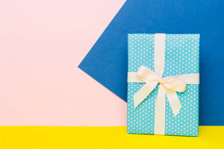 holiday paper present tied yellow ribbon bow top view with copy space. Flat lay holiday background. birthday or christmas present. Christmas gift box concept with copy space.の写真素材