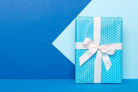 holiday handmade paper present tied white ribbon bow top view with copy space. Flat lay holiday background. birthday or christmas present. Christmas gift box concept with copy space.の写真素材