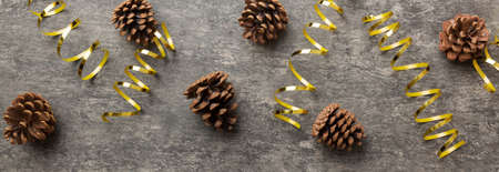 New Year composition. Christmas decor background with pine cones. Top view with copy space.