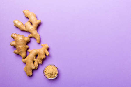 Finely dry Ginger powder in bowl isolated on colored background. top view flat lay.
