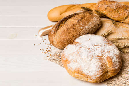 Homemade natural breads. Different kinds of fresh bread as background, perspective view with copy...