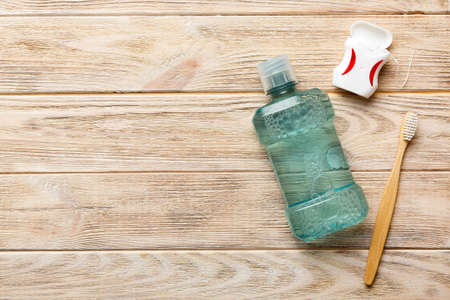 Mouthwash and other oral hygiene products on colored table top view with copy space. flat lay. dental hygiene. Oral care products and space for text on light background. concept.の写真素材