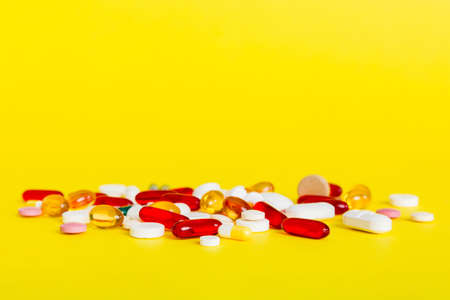 Many different colorful medications and pills perspective view. Set of many pills on colored background.の写真素材