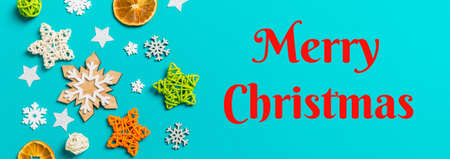 Merry christmas text. Banner top view of blue background with New Year toys and decorations....