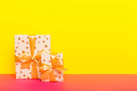 holiday paper present tied yellow ribbon bow top view with copy space. Flat lay holiday background. birthday or christmas present. Christmas gift box concept with copy space.の写真素材