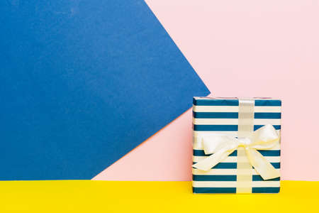 holiday paper present tied yellow ribbon bow top view with copy space. Flat lay holiday background....