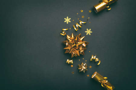 Christmas crackers with shiny confetti on color background, top view, copy space.の写真素材