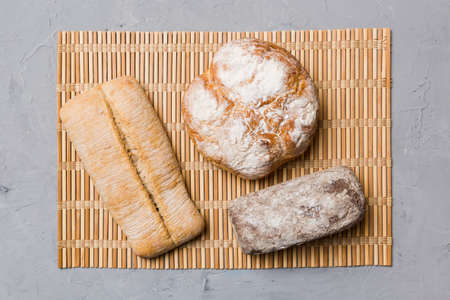Assortment of freshly baked bread with napkin on rustic table top view. Healthy unleavened bread....