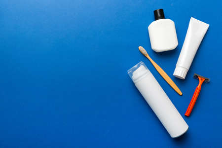 Composition with bath cosmetics on table. razor, toothpaste, soap, gel, toothbrush, mouthwash and...
