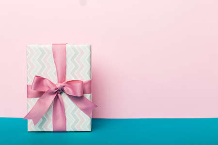 holiday paper present tied pink ribbon bow top view with copy space. Flat lay holiday background. birthday or christmas present. Christmas gift box concept with copy space.の写真素材