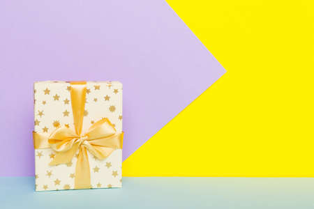 holiday paper present tied yellow ribbon bow top view with copy space. Flat lay holiday background. birthday or christmas present. Christmas gift box concept with copy space.の写真素材